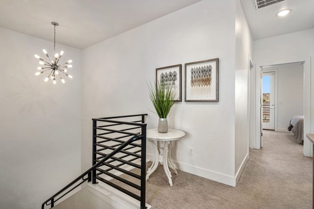 Upstairs landing with modern railing and accent table