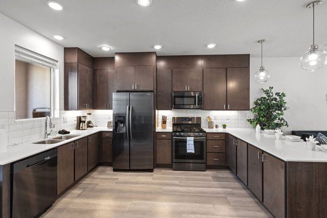 Full kitchen with stainless refrigerator, gas range and dishwasher