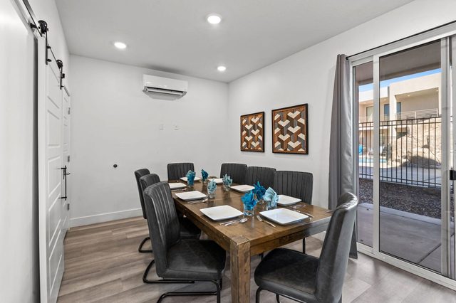 Dining table for eight beside sliding doors to the patio