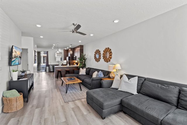 Open living room with sectional sofa looking toward the kitchen