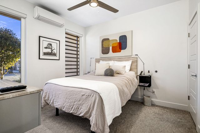 Downstairs Bedroom 1 with queen bed and window