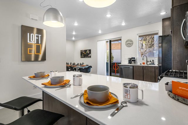 Kitchen bar with place settings and The Lofts wall sign