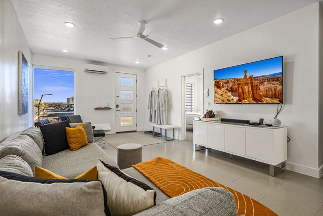Living room sectional and smart TV at The Lofts 20