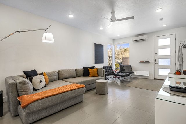 Living room sectional, lounge chair and front door