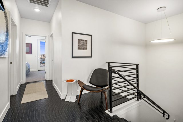 Upstairs landing with accent chair and stair railing