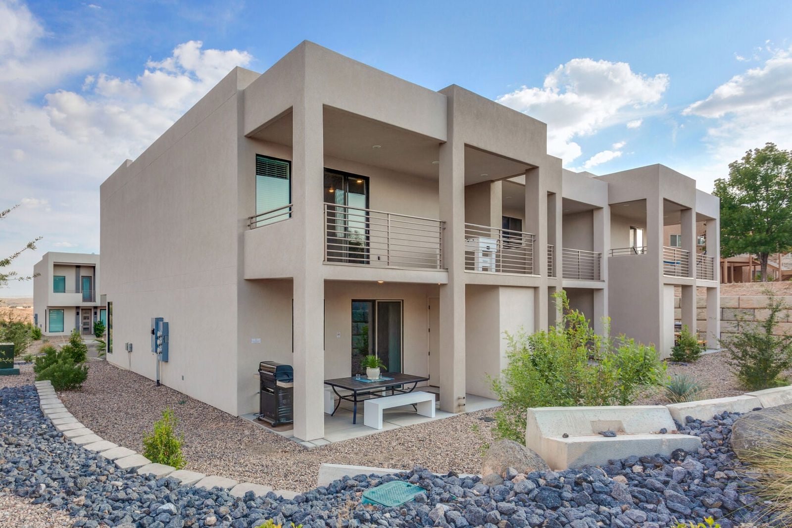 Two-story exterior of The Lofts 37 with back patio