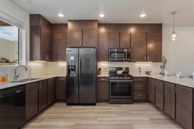 Kitchen with stainless refrigerator, gas range and dishwasher