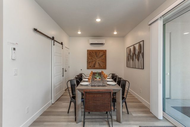 Dining room table with patio slider and wall art