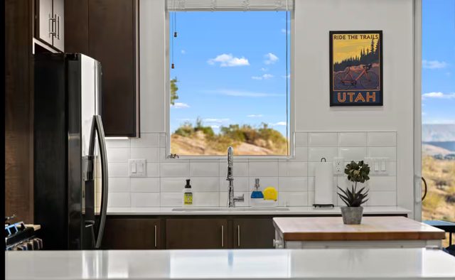 Kitchen sink window with desert view and quartz counters