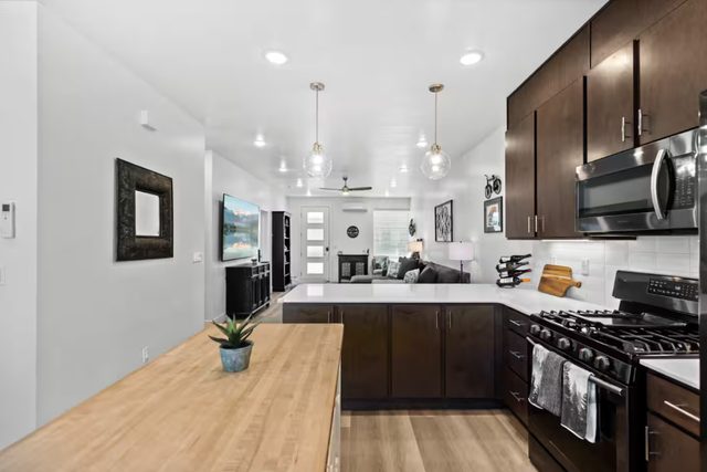 Kitchen island and gas range looking toward the living room
