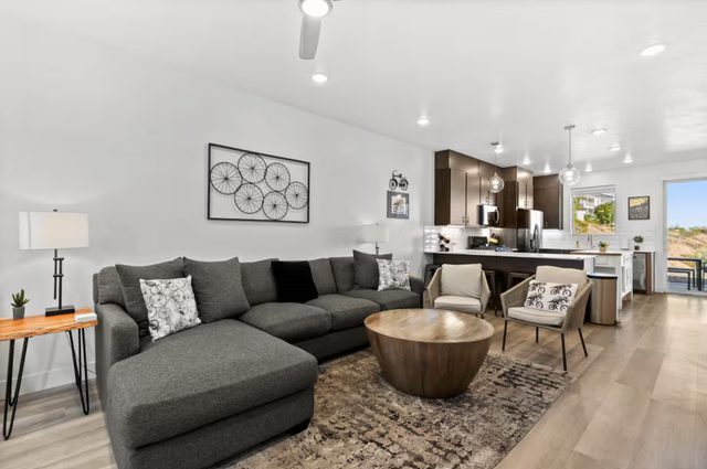 Living room gray sectional and round coffee table at The Lofts 45