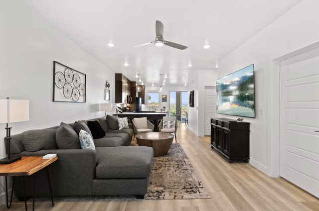 Sectional sofa facing a large wall-mounted smart TV