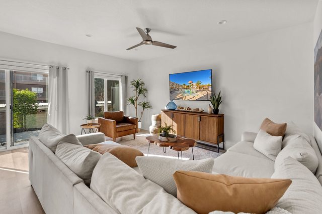 Living room sectional with throw pillows and patio doors