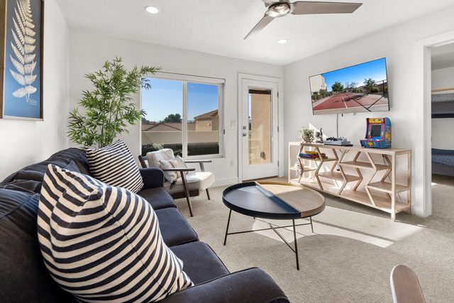 Loft lounge with sofa, round coffee table and TV