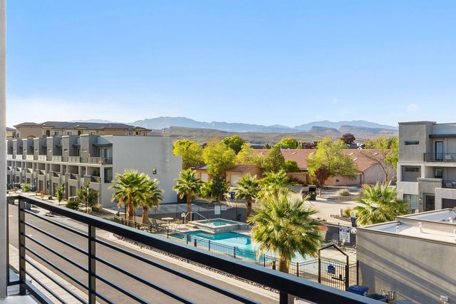 Balcony view over the community pool toward distant mountains