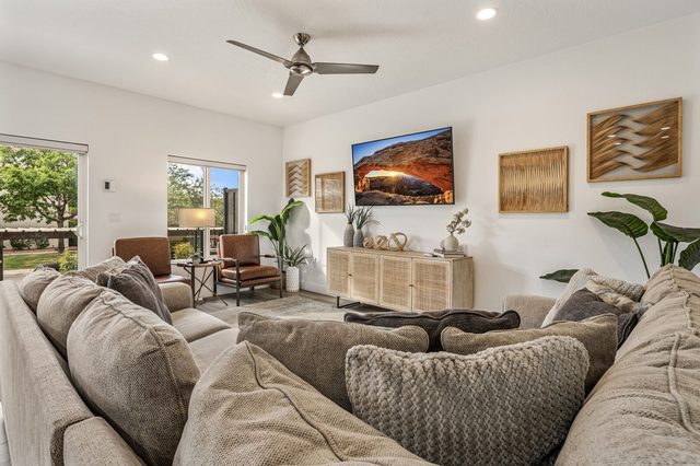 Living room with oversized sectional and wall TV at The Vues 5