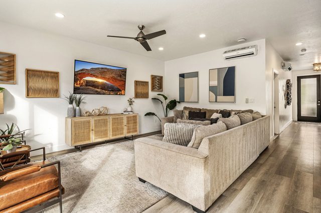 Living room seating with hallway to the front entry