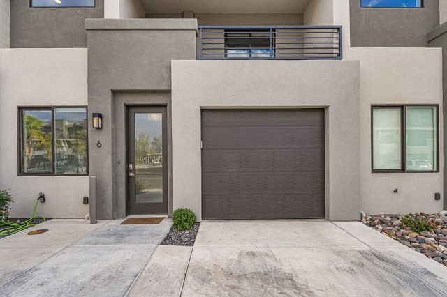 Front entry and single garage of The Vues 6 townhome