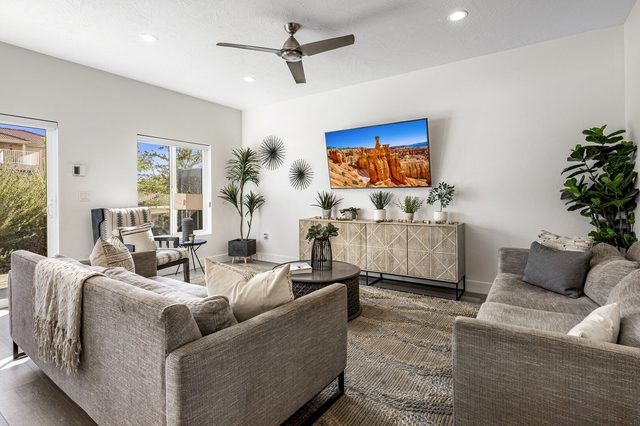 Living room with two sofas and wall-mounted TV at The Vues 6