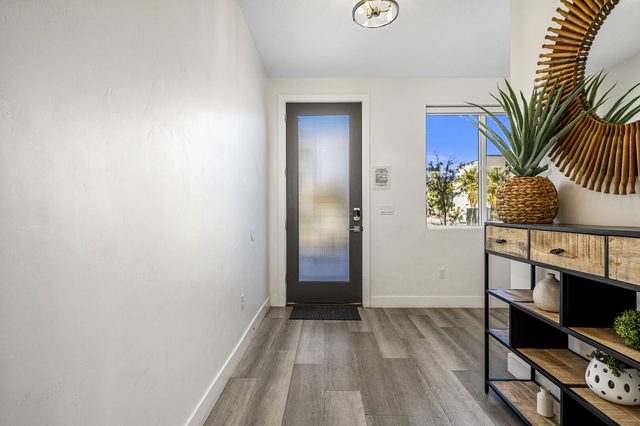 Entry hall with glass front door and console shelf