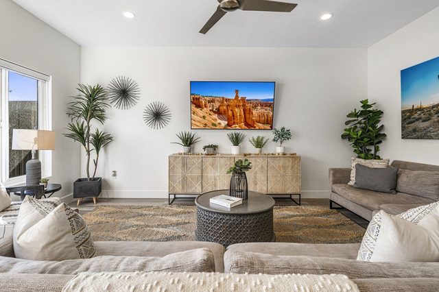 Living room with TV console, sofas and round coffee table