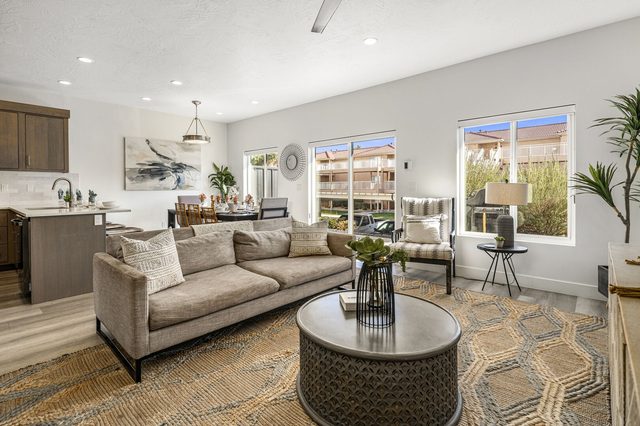 Living room sofas with kitchen and dining area behind