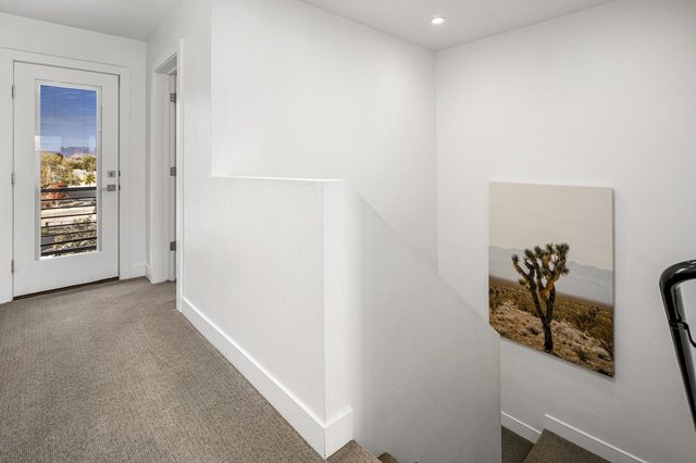 Upstairs landing with balcony door and artwork