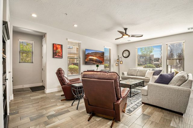 Living room with leather recliners, sofa and wall TV