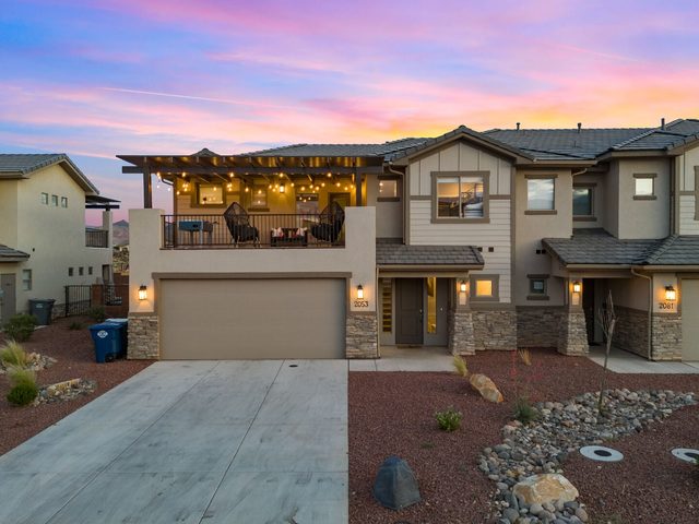 Front exterior of Zion Village 2053 townhome with garage at sunset