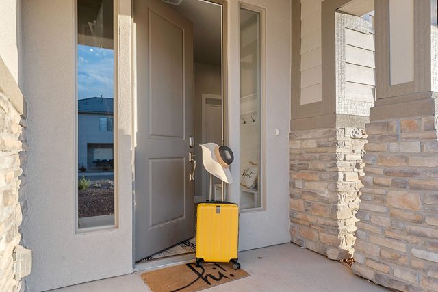 Covered front entry with stone columns and front door
