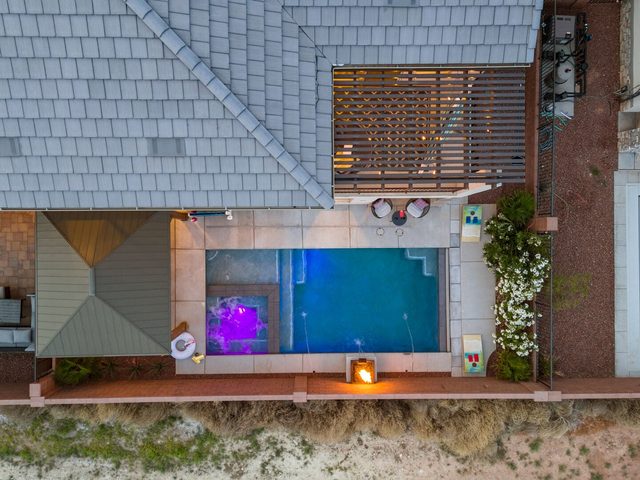 Overhead drone view of the private pool, hot tub and patio