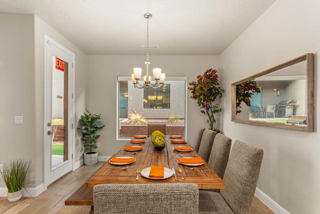Dining table set for eight with chandelier and patio door