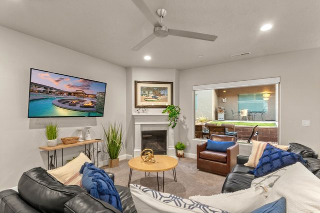 Living room with fireplace, wall TV and leather sofas