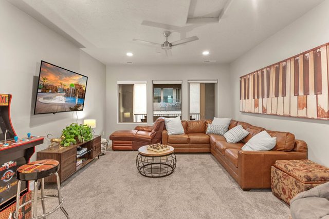 Upstairs loft with leather sectional, TV and arcade cabinet
