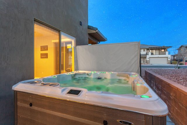 Private hot tub on the backyard patio at dusk
