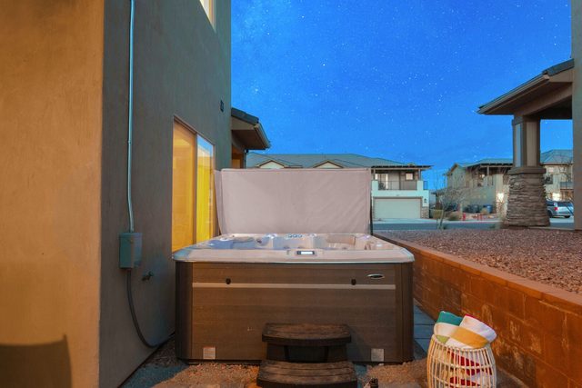 Private hot tub beside the house with privacy screen