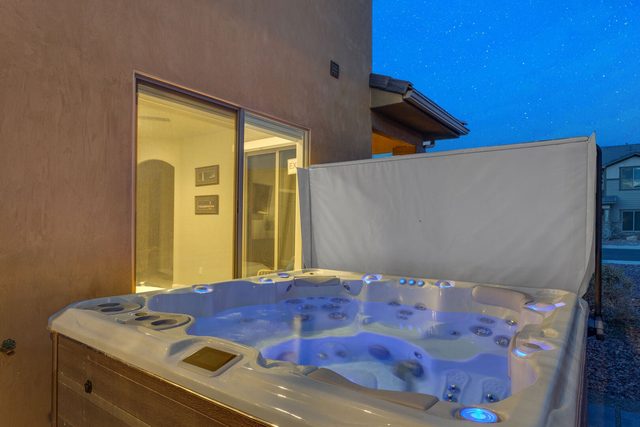 Illuminated private hot tub next to the patio door