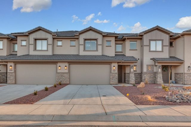 Front of the townhome row with two-car garages and driveways