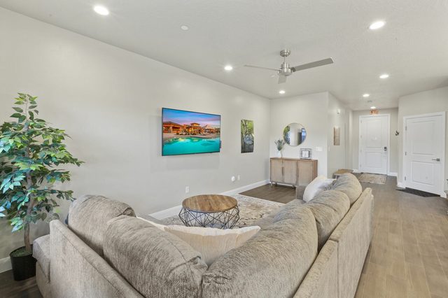 Living room with sectional sofa, round coffee table and TV