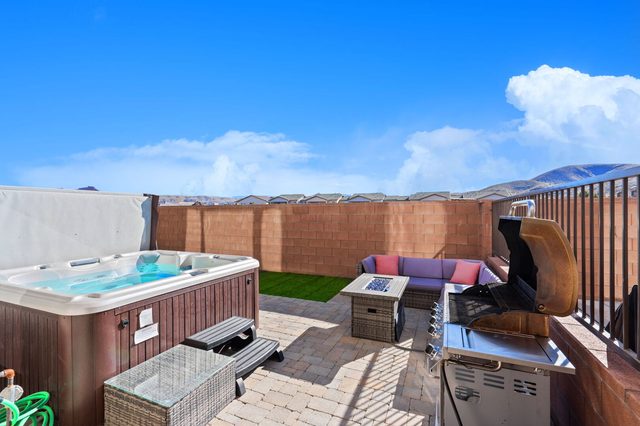 Private hot tub on the paver patio with grill and seating