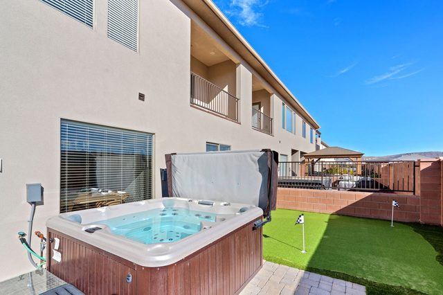 Private hot tub on the patio beside the putting green
