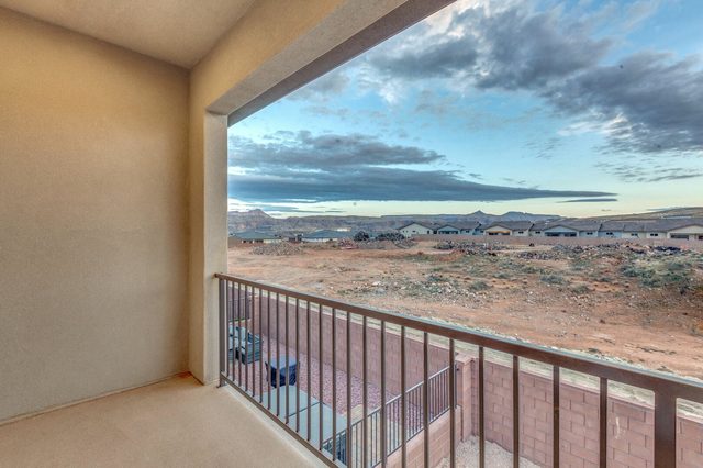 Covered balcony view across the desert toward distant mountains