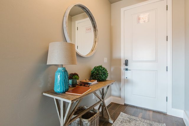 Entry console with lamp and round mirror by front door