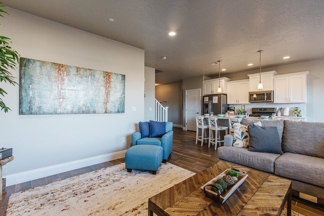 Living room with sectional and view toward the kitchen