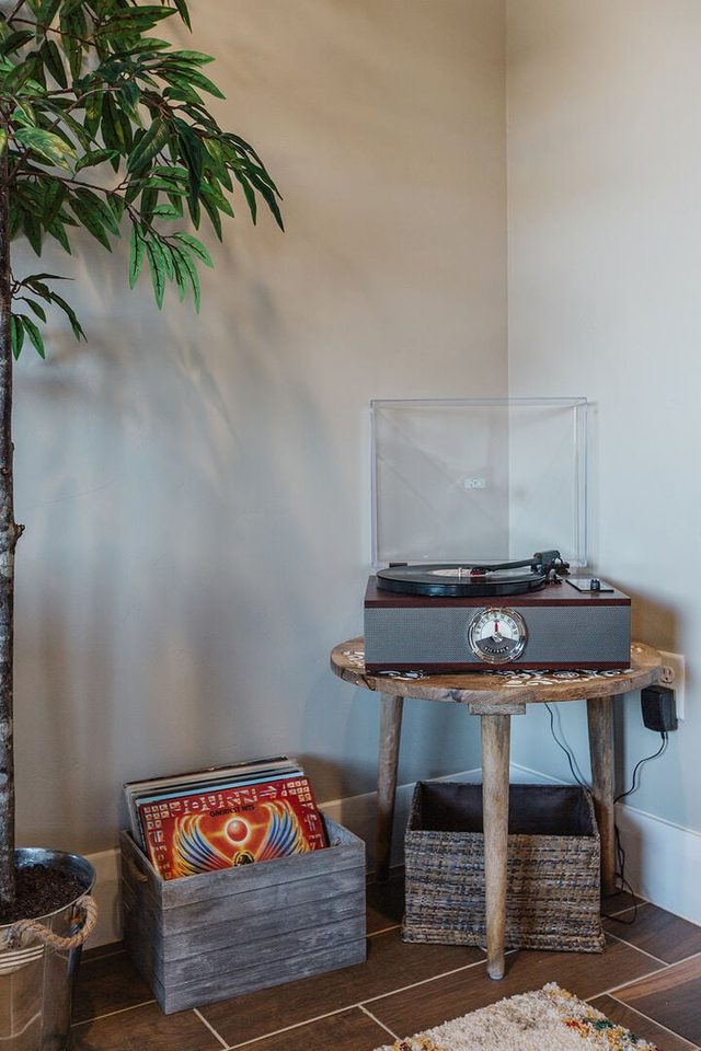 Record player on side table with vinyl records