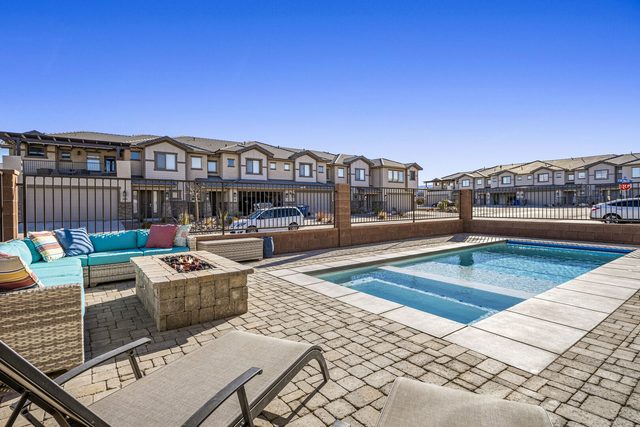 Private pool with fire pit and outdoor sectional in daylight