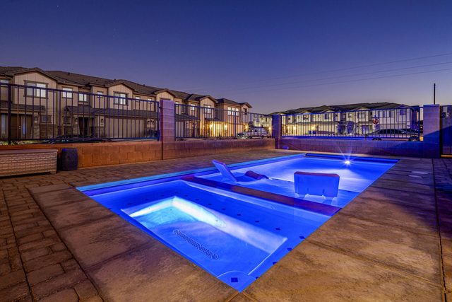 Private pool and hot tub glowing blue at night