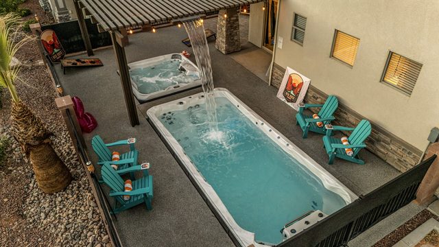Overhead view of private swim spa and hot tub with Adirondack chairs