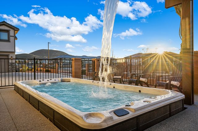 Private swim spa with water feature and fenced backyard
