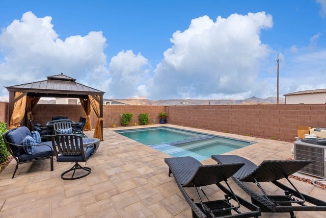 Private pool with lounge chairs and gazebo seating